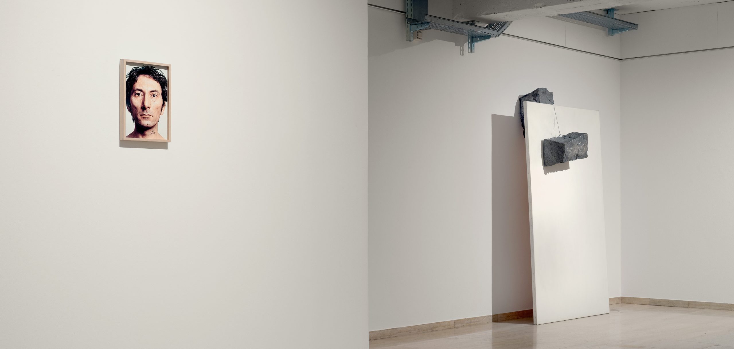 Installation view of Giovanni Anselmo’s exhibition at Repetto Gallery in Lugano, with artworks displayed throughout the white gallery space.
